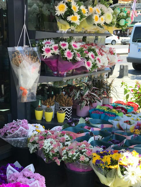 A vibrant display of fresh floral arrangements outside a flower shop on Stroud Green Road, Finsbury Park, featuring a variety of bouquets with daisies, chrysanthemums, and other colorful blooms. The t